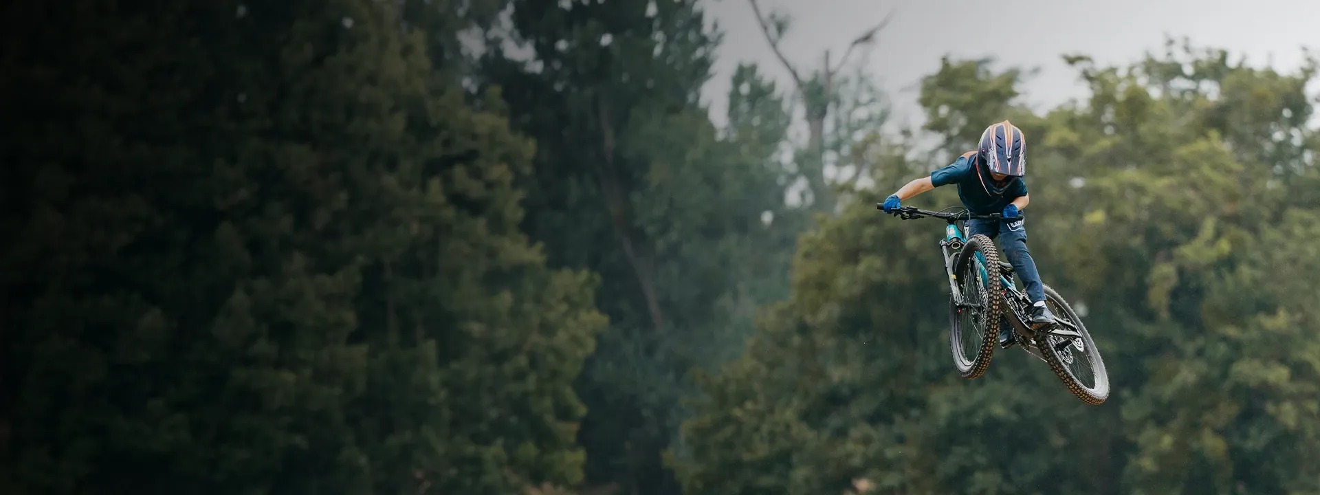Young mountain biker wearing full-finger gloves on a trail