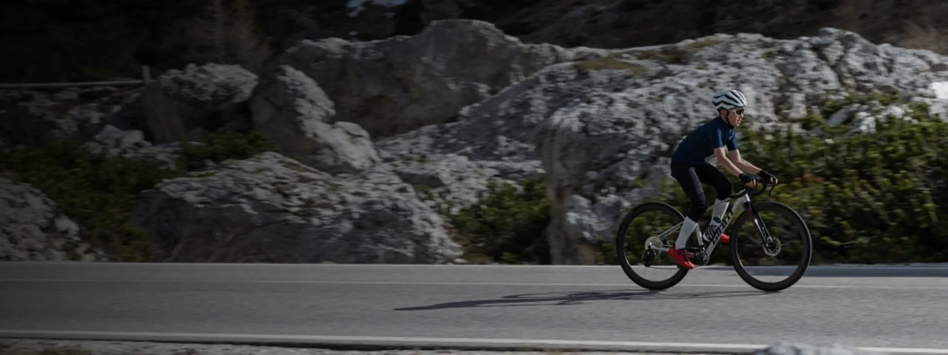 Young road cyclist wearing lightweight cycling gloves