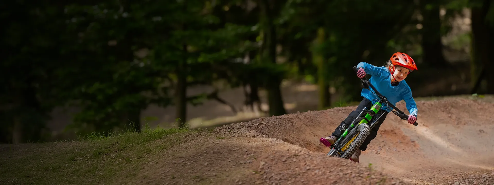 Young rider wearing cycling gloves while riding a bike outdoors