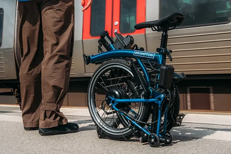 Brompton folding bike folded on a station platform