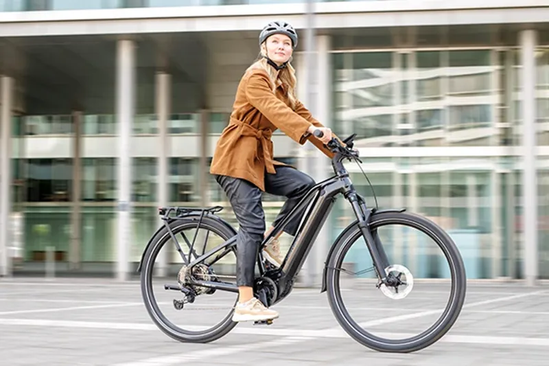 Woman riding an electric urban bike in the city