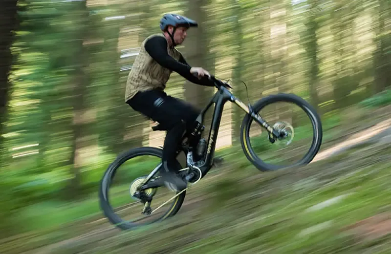 Chris Akrigg climbing a steep woodland trail on a Whyte Karve RSX