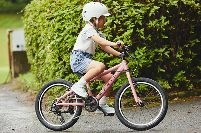 Child riding a mid-size Marin kids bike on a path