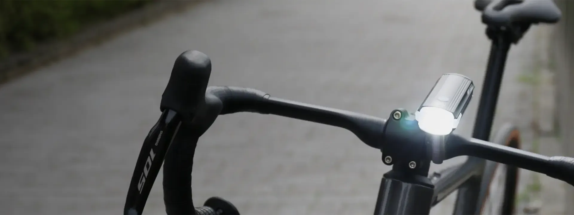 Front bike light mounted on a road bike's handlebars
