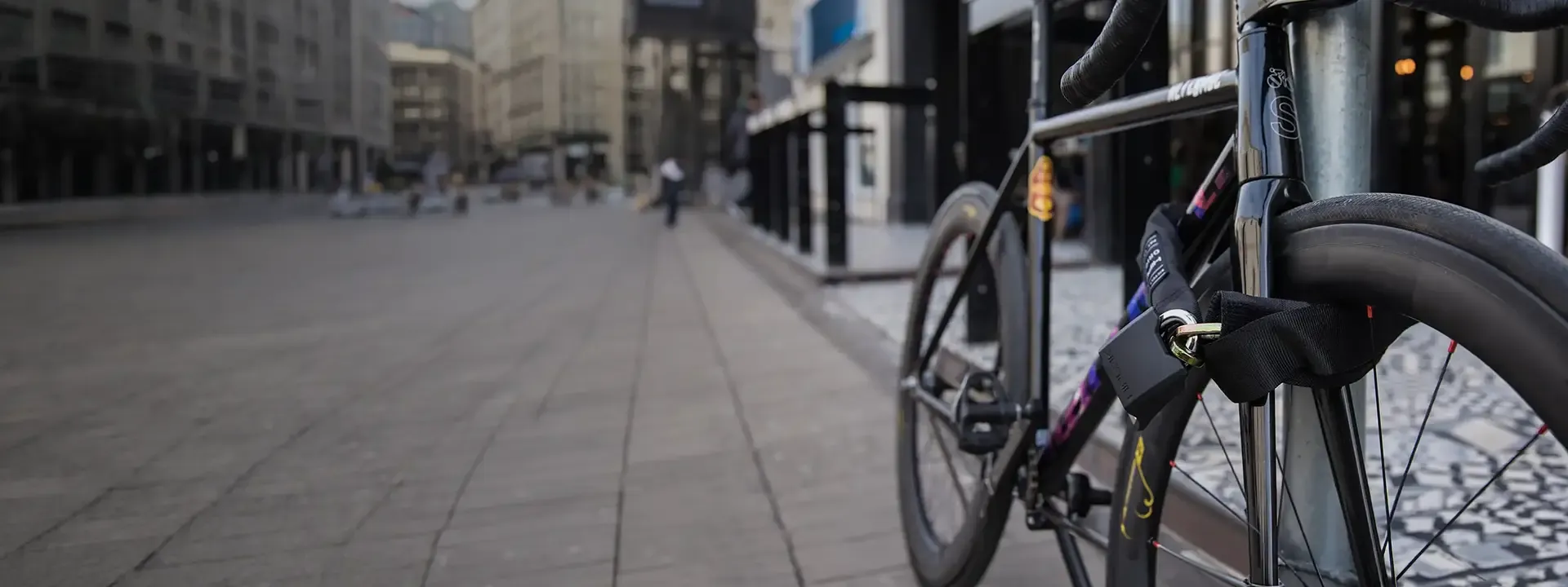 Bicycle secured to a city cycle stand with a chain lock