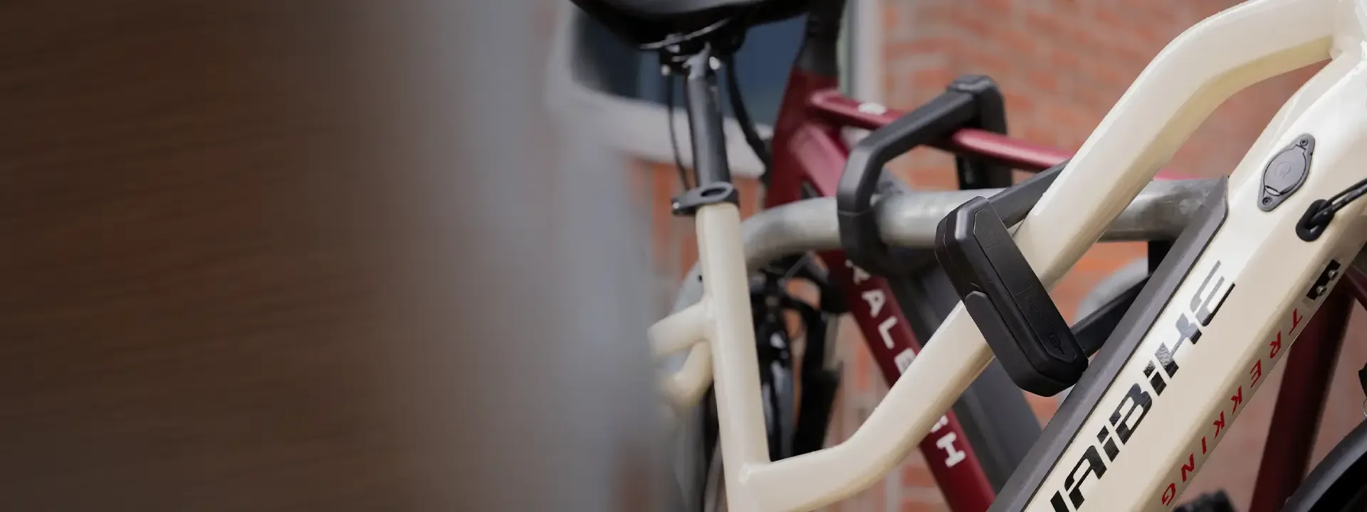 Diamond-rated D-lock securing a bicycle to a cycle stand