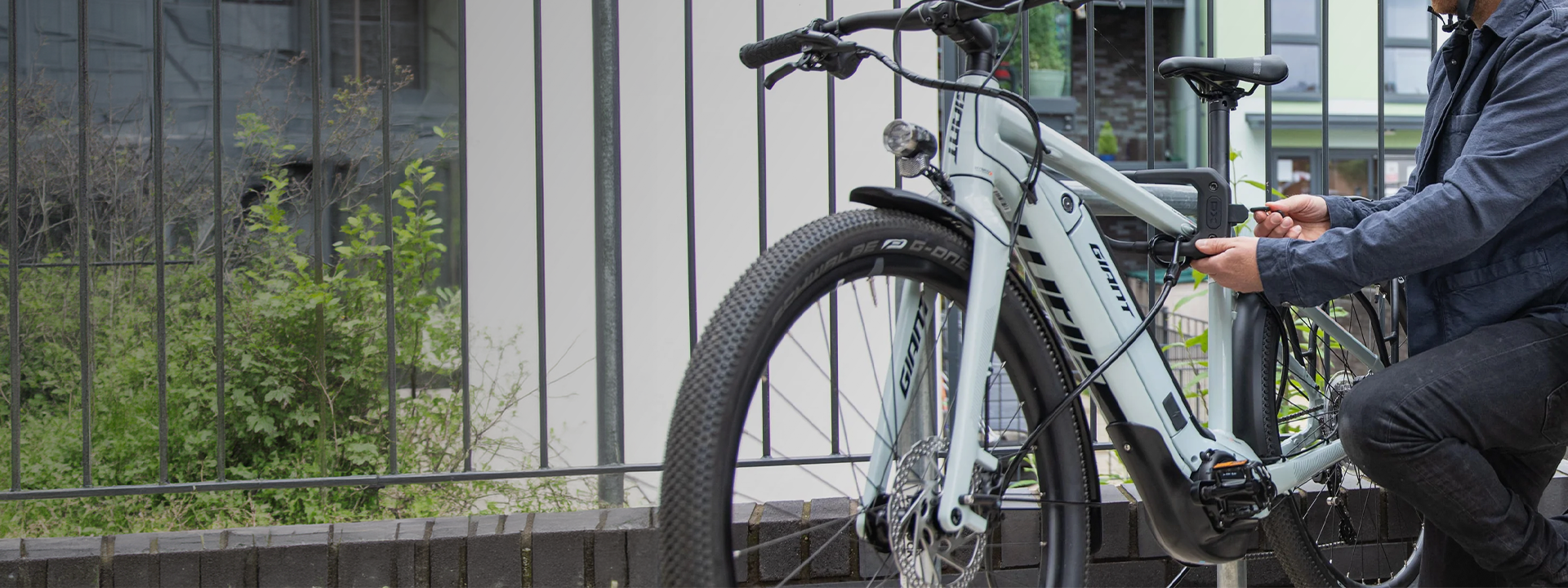Cyclist securing a bicycle wheel with an extension cable
