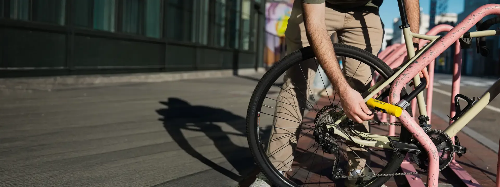 Cyclist securing a bike with a Gold-rated bike lock
