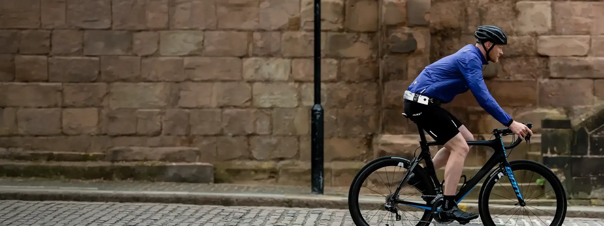 Cyclist carrying a wearable bike lock while riding