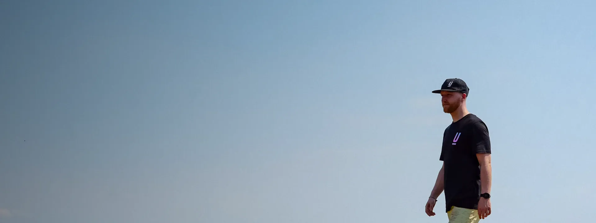 Mountain biker wearing a cap and helmet liner on a trail ride