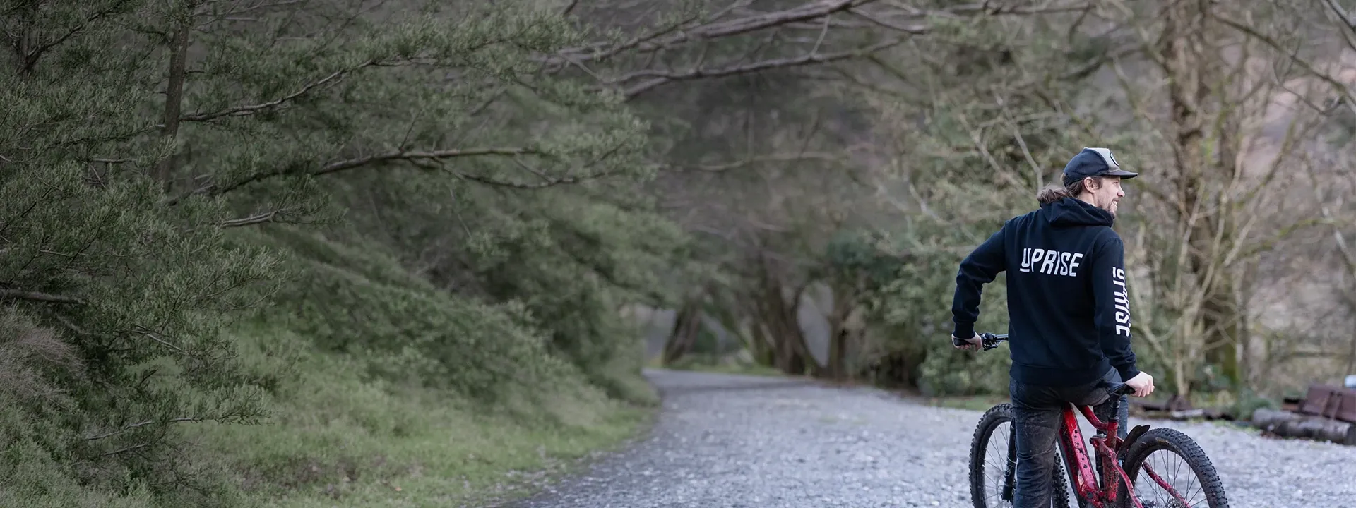 Mountain biker wearing an MTB hoodie on a trail ride
