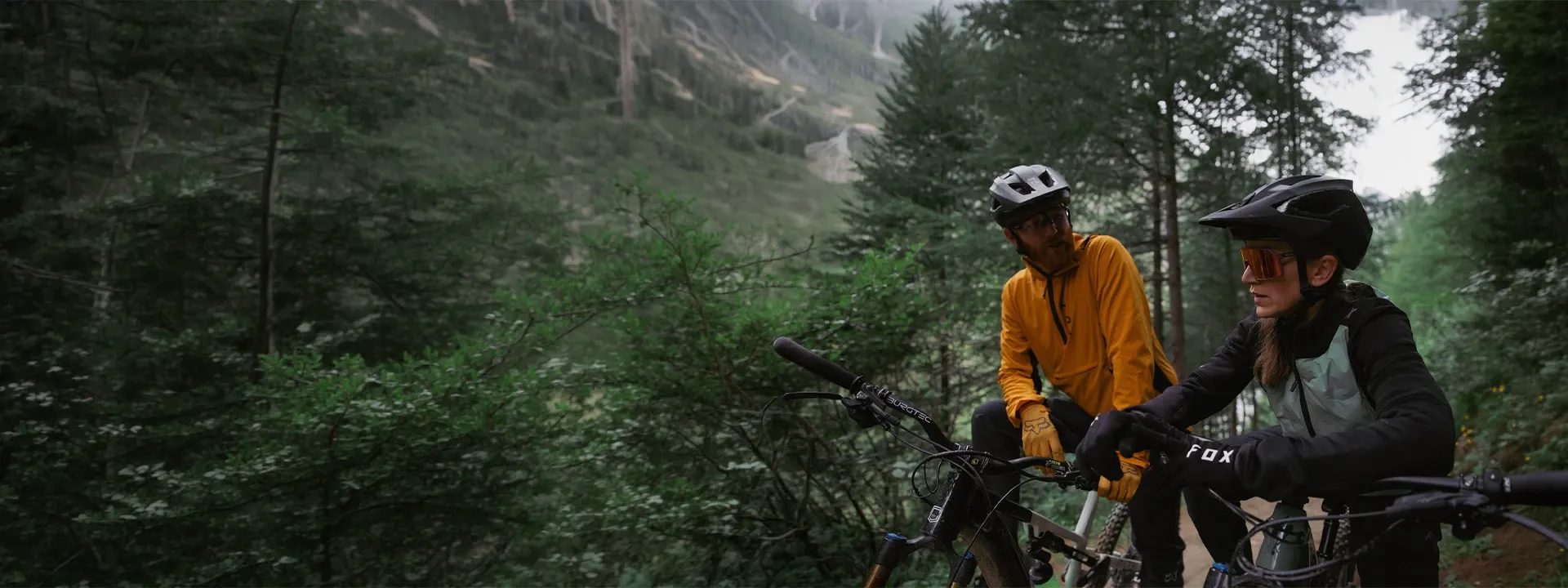 Mountain biker wearing a windproof MTB jacket on an exposed trail ride