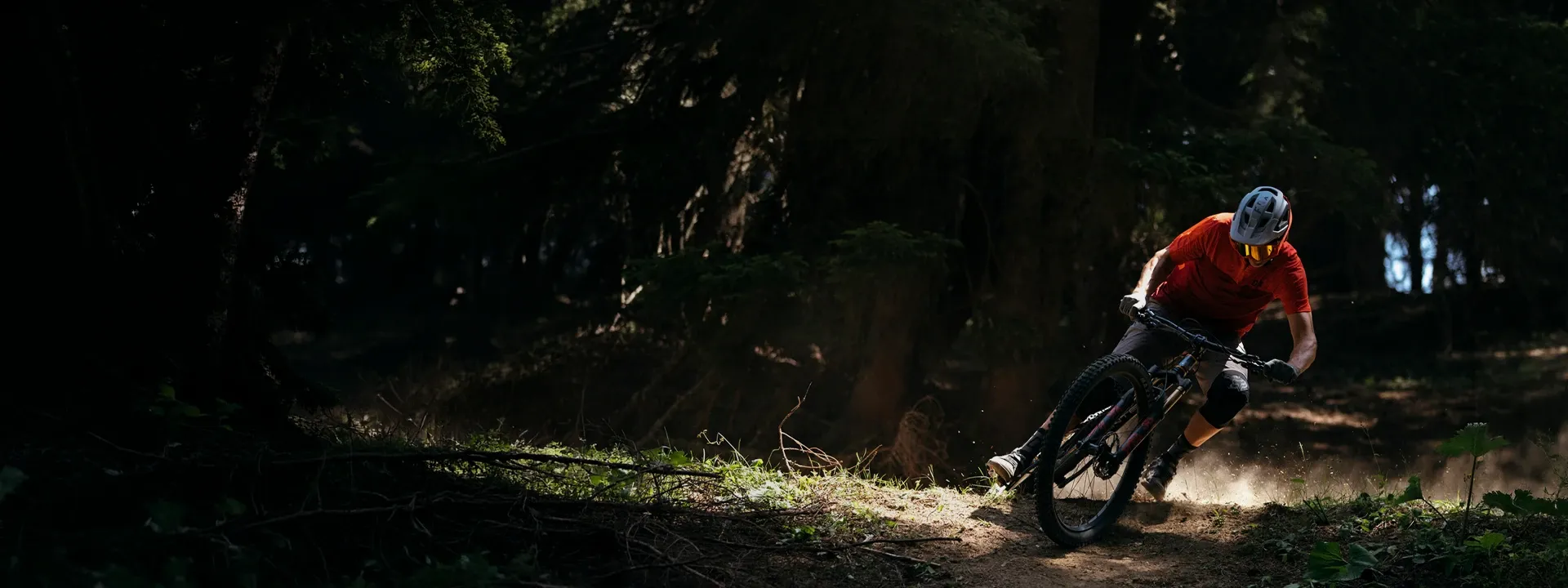 Mountain biker wearing a short sleeve jersey on a summer trail ride