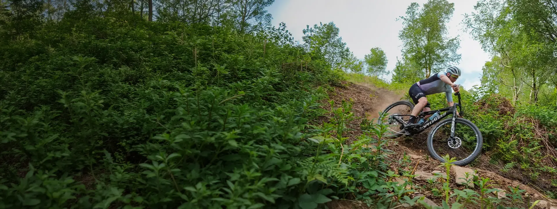 Rider descending on a full suspension mountain bike