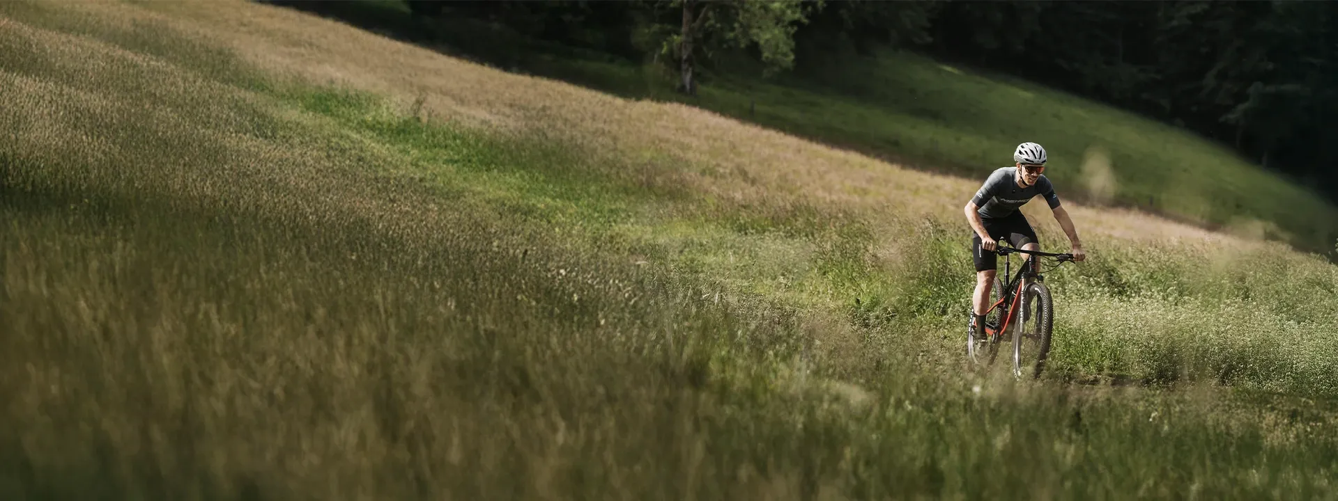 XC mountain bike racing across open terrain
