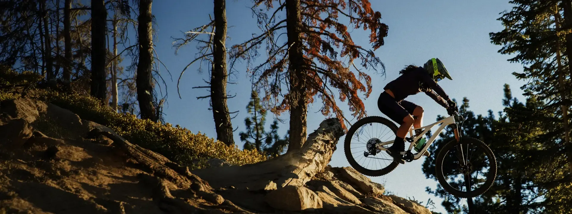 Female mountain biker wearing baggy shorts on a trail ride