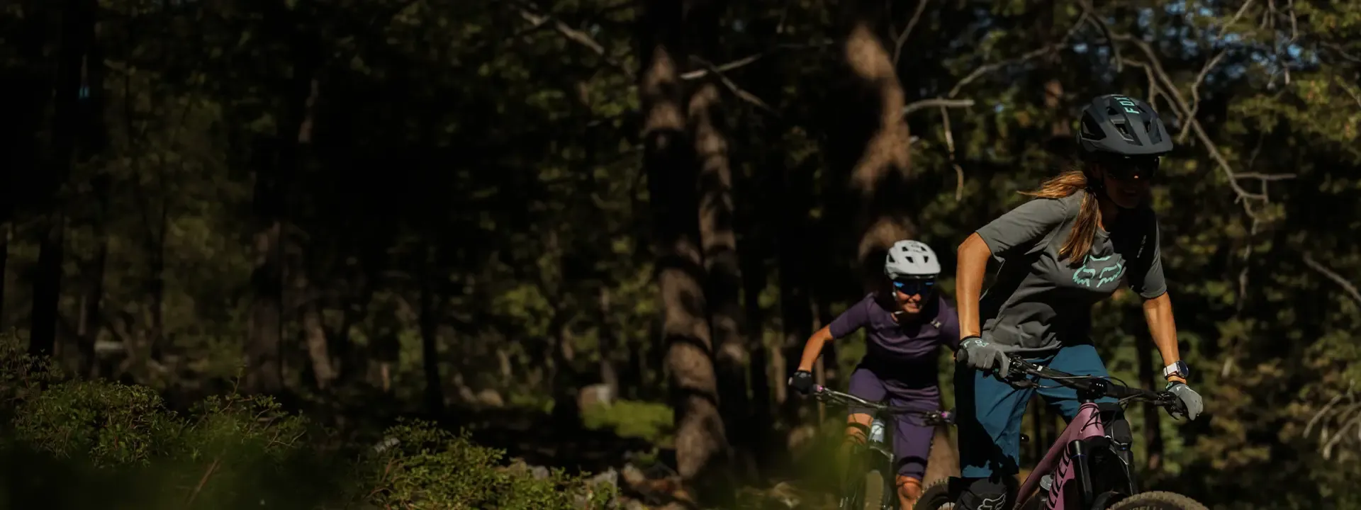 Female mountain biker wearing an MTB jersey on a trail ride