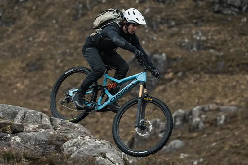 Riding an Orbea Occam LT Full suspension mountain bike on a rocky trail