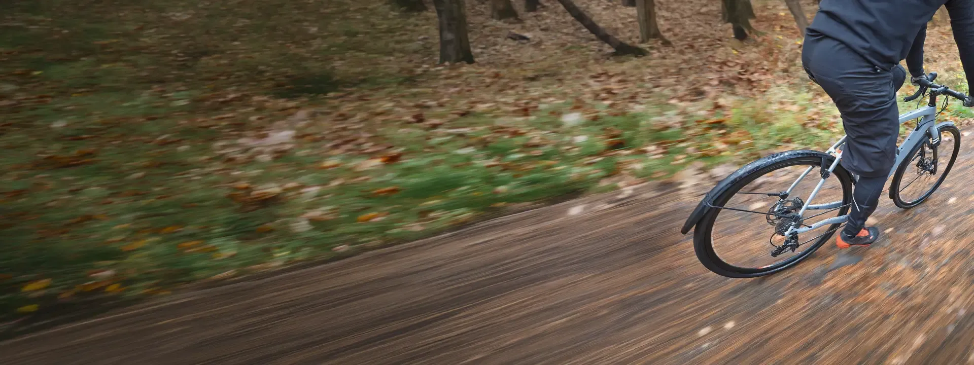Road cyclist riding in wet conditions with mudguards fitted
