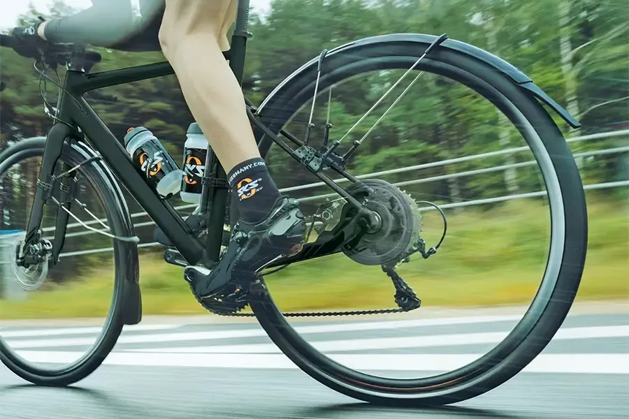 Close-up of a cyclist riding on the road with a rear mudguard fitted