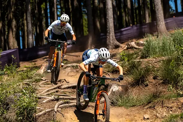 Orbea Oiz riders descending a root-covered woodland trail