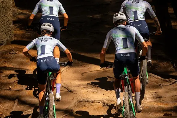 Orbea Oiz riders climbing a steep forest trail