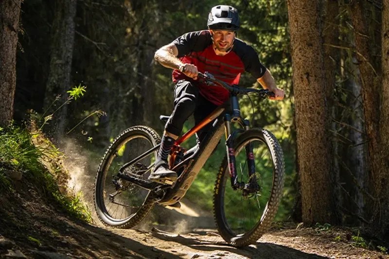 Rider descending a rocky trail on an Orbea Wild electric mountain bike