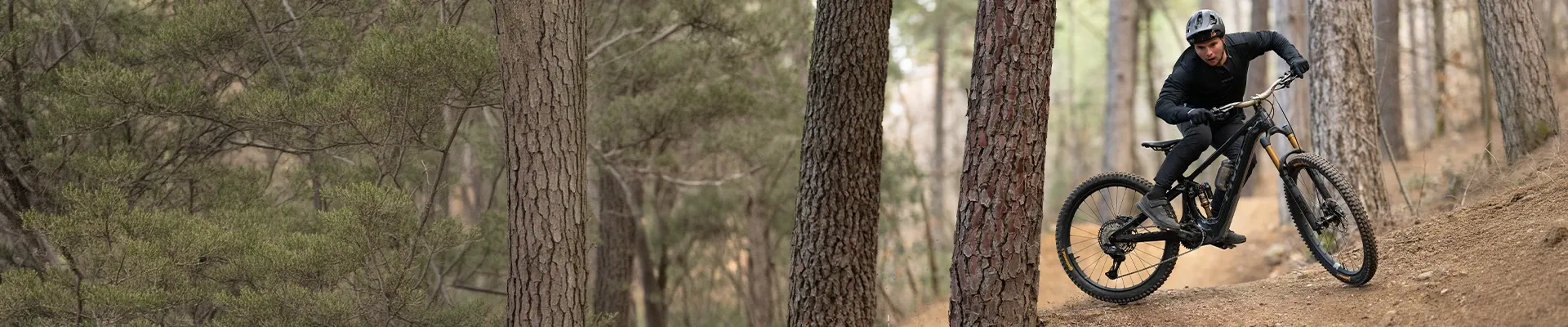 Pivot Shuttle AMP'd electric mountain bike stylish riding on aggressive trail terrain