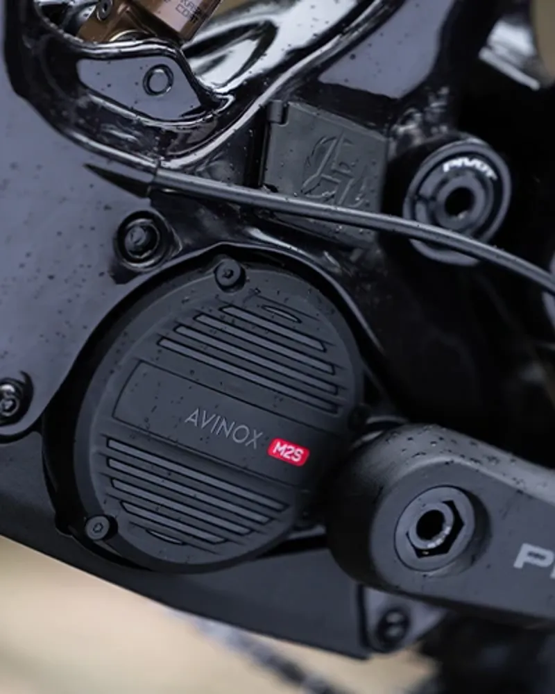 Close-up of the Avinox M2S motor mounted in the Pivot Shuttle AMP&rsquo;d frame near the crank area.