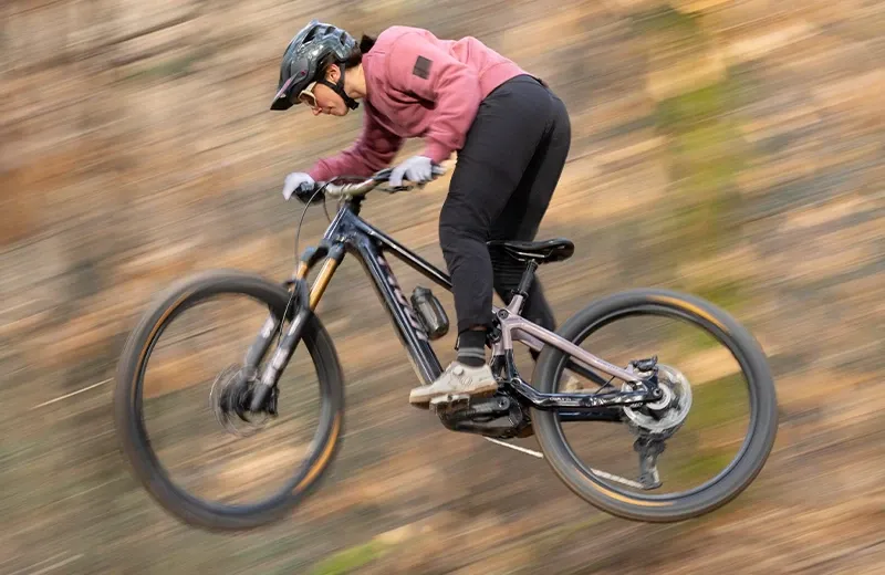 Getting air on the Pivot Shuttle AMP'd pan shot side profile showing aggressive frame and suspension layout