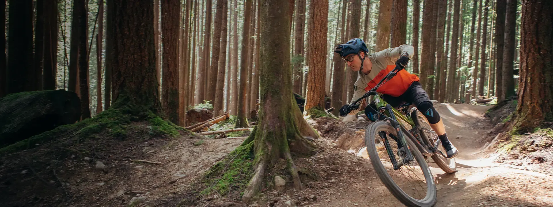 Mountain biker wearing knee pads on a technical trail