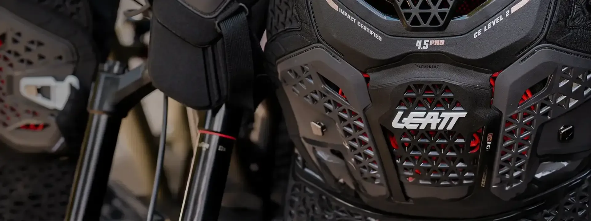Mountain biker wearing Leatt body armour on technical terrain