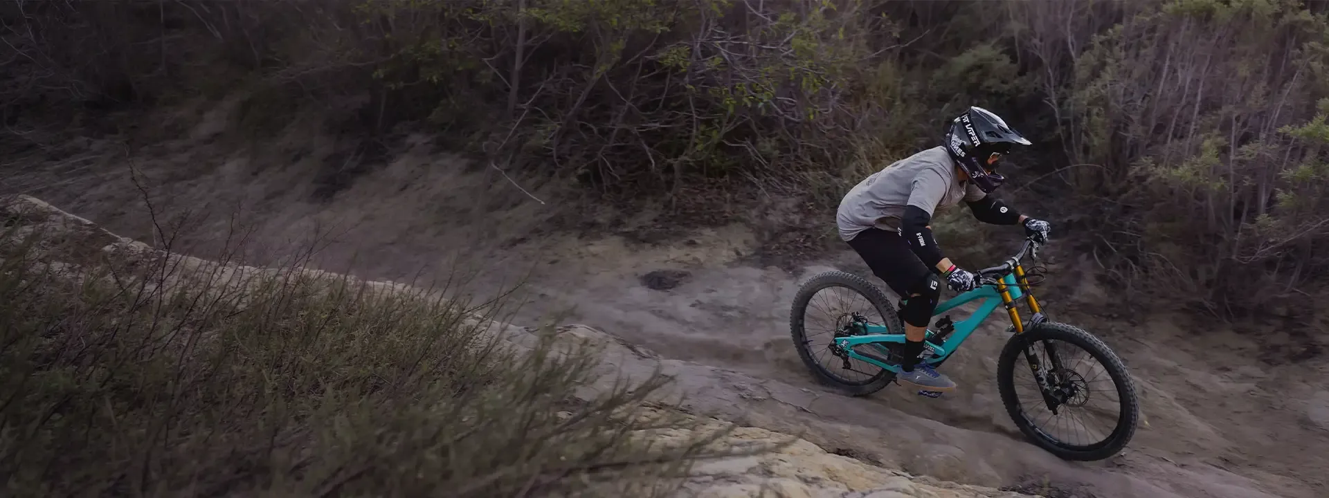 Mountain bike rider wearing body armour on technical terrain