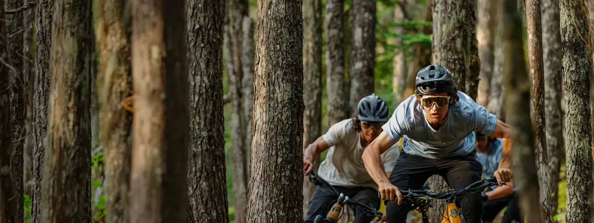 Mountain biker wearing Coast Optics eyewear on a trail ride