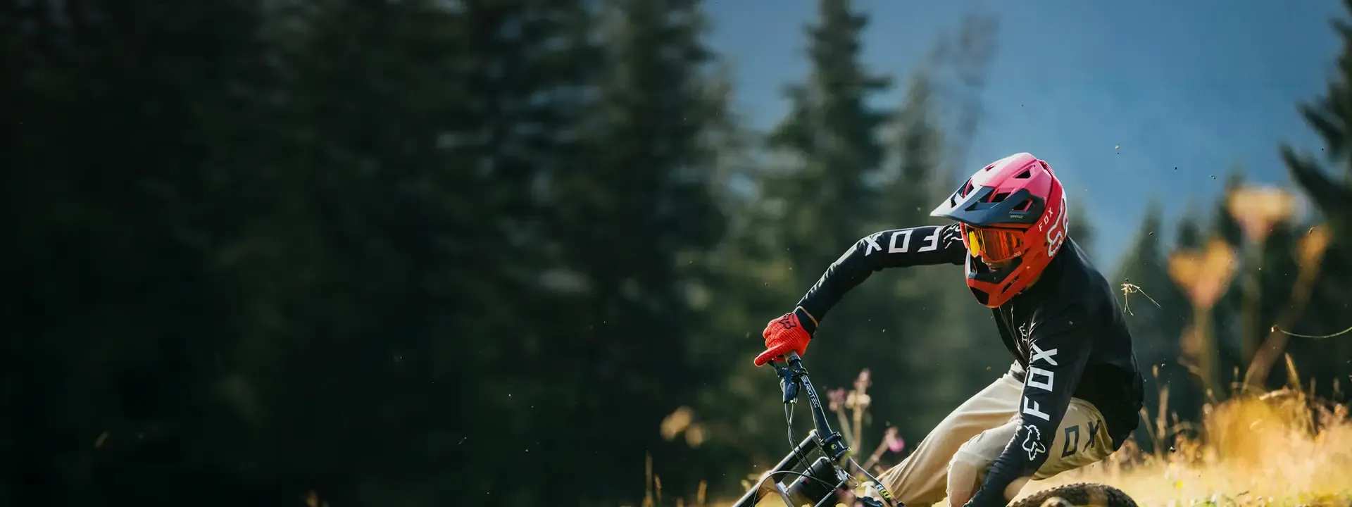 Mountain biker wearing Fox eyewear on a technical trail
