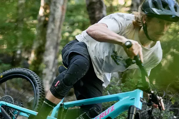 Mountain bike rider wearing body armour and knee protection