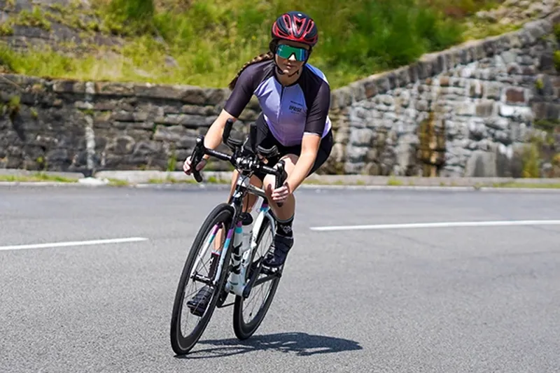 Woman riding a road bike on a sunny day