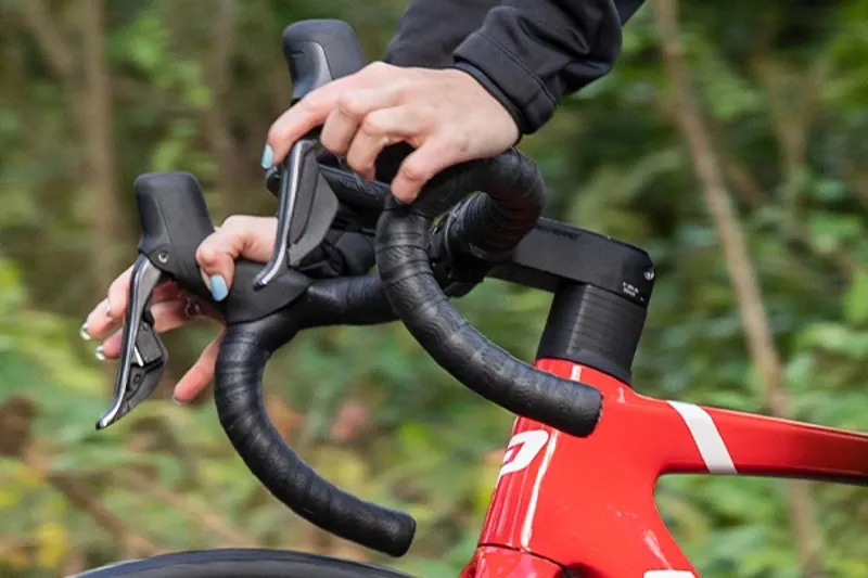 hands on road bike handlebars and levers