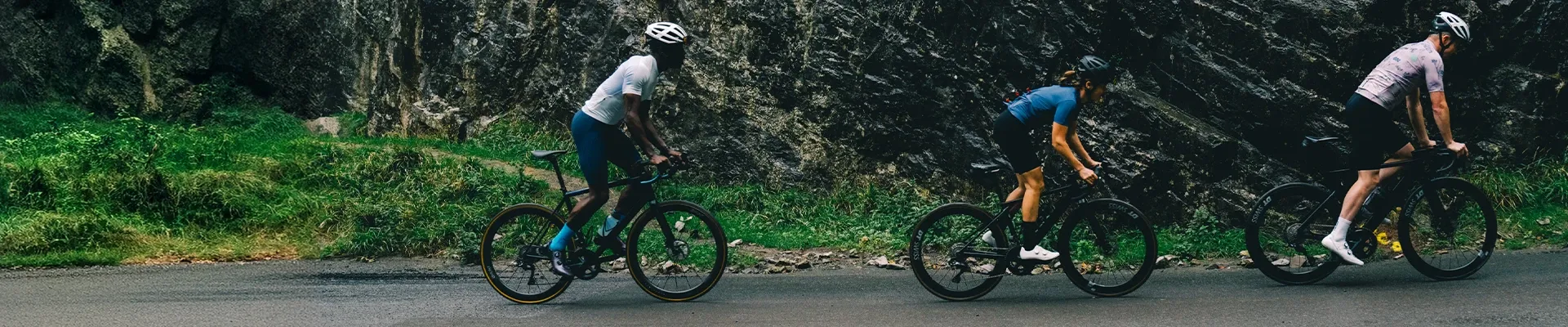 Road cyclists riding in technical clothing on an open road