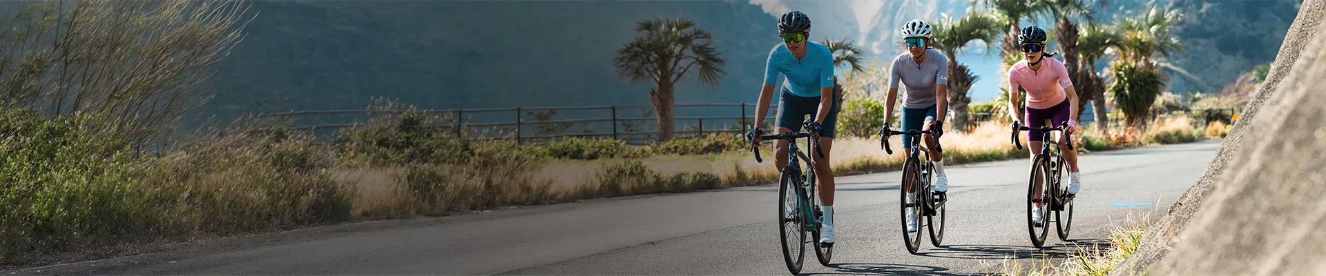 Cyclists riding on open roads wearing performance cycling clothing