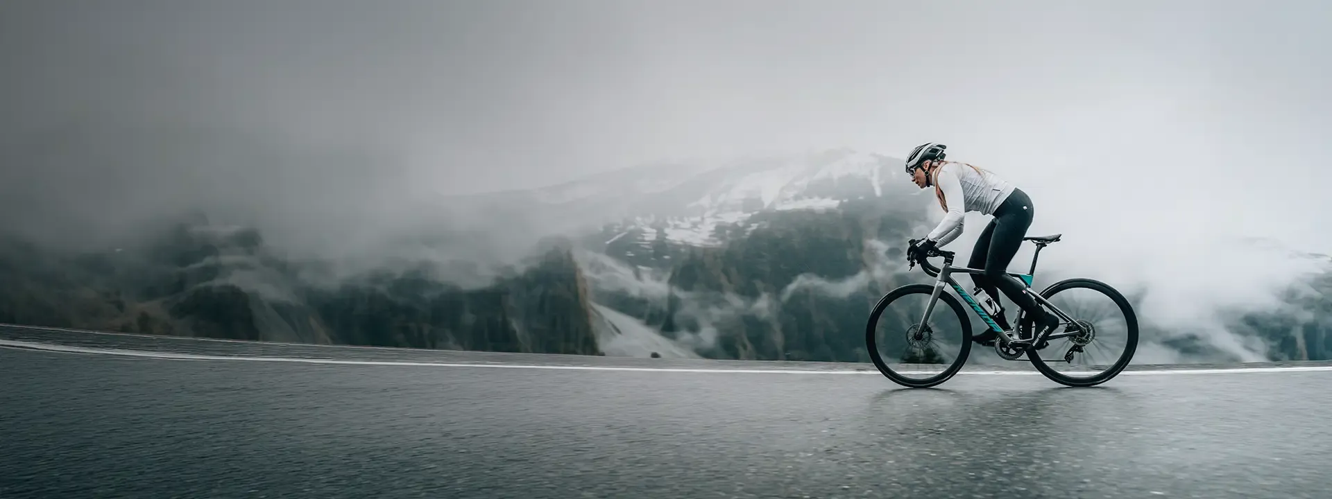 Female road cyclist wearing thermal bib tights during winter road riding