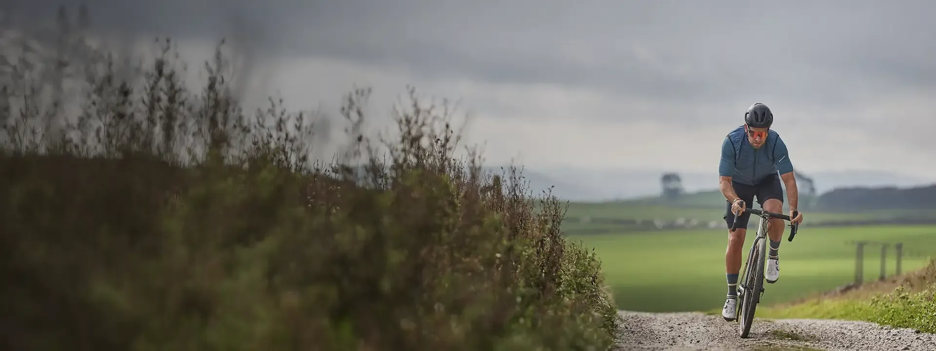Road cyclist wearing a lightweight cycling gilet on a cool road ride