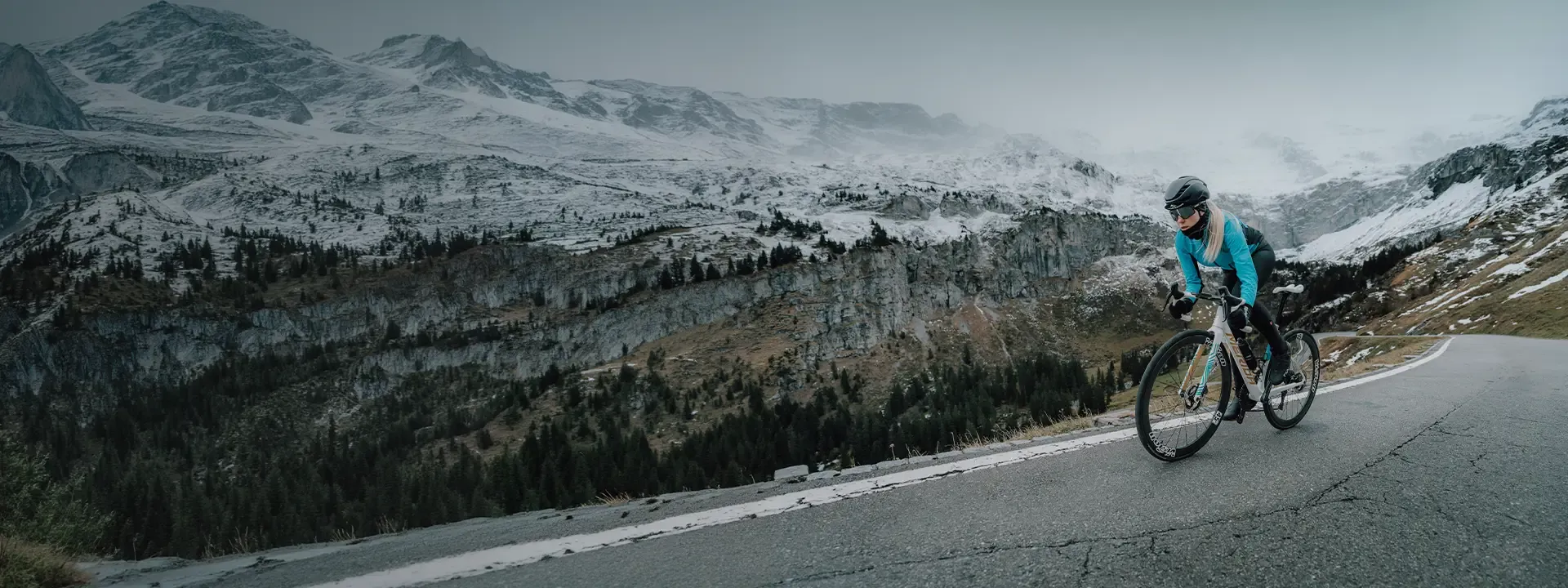 Road cyclist wearing a showerproof jacket in cool and damp riding conditions