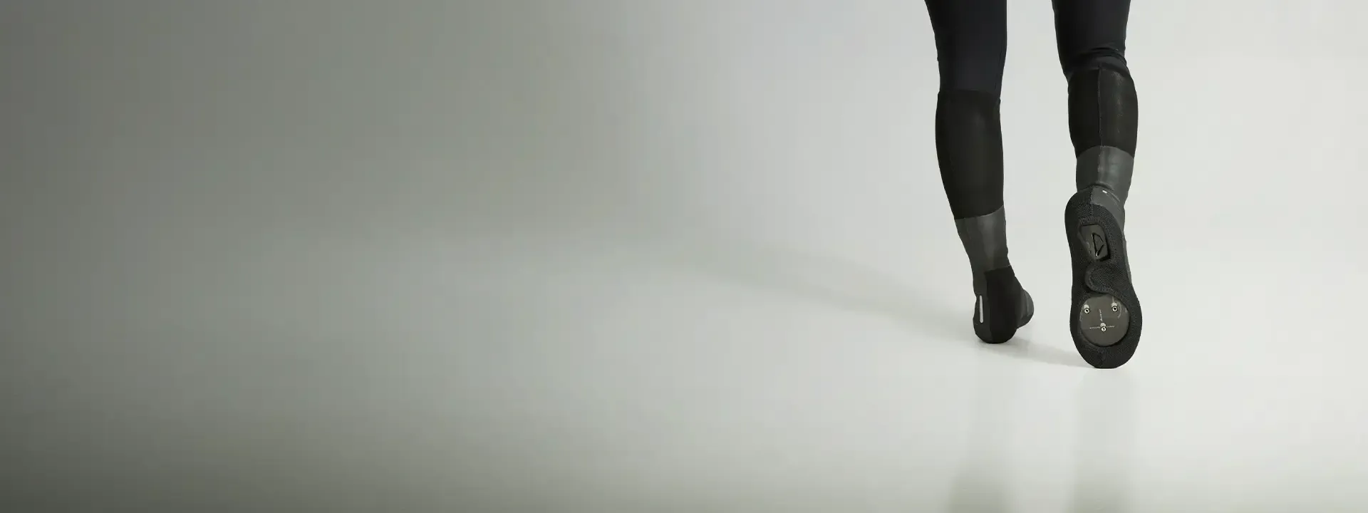 Road cyclist wearing overshoes in cold and wet riding conditions