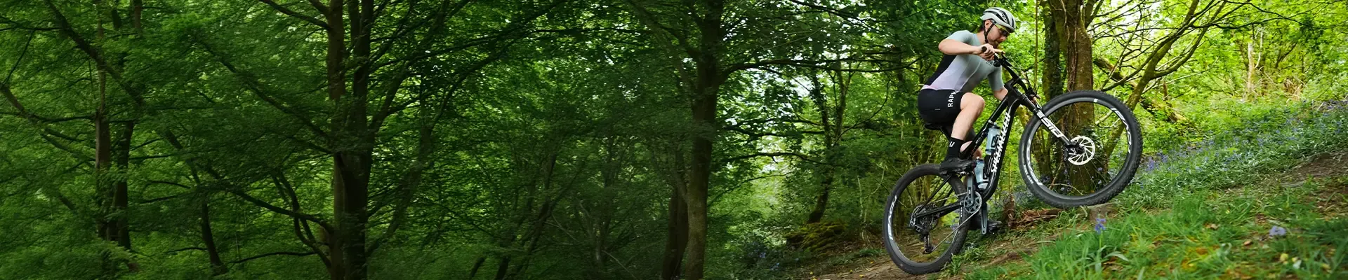 RIding the Specialized Epic 9 full suspension XC race mountain bike on a steep woodland trail in Wales