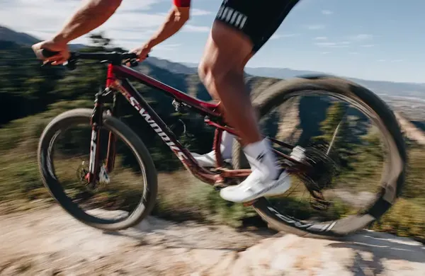 Riding the Specialized Epic 9 on a rocky trail in the mountains