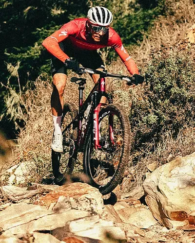 Riding the S-Works Epic 9 XC race bike on a rocky trail