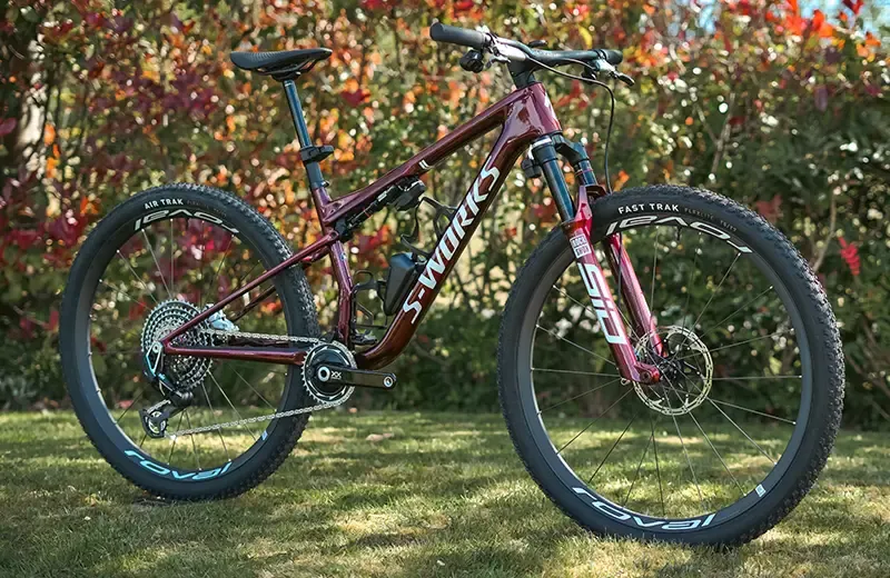 Riding a steep technical turn on the Specialized Epic 9 XC race mountain bike
