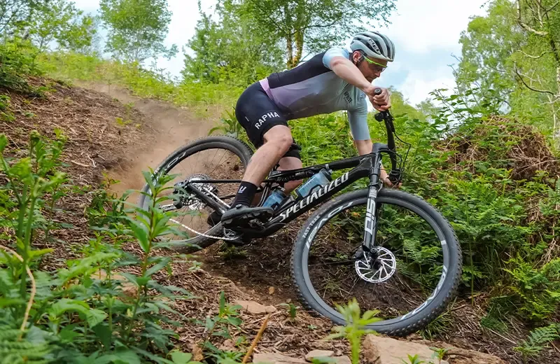 Riding a steep technical turn on the Specialized Epic 9 XC race mountain bike