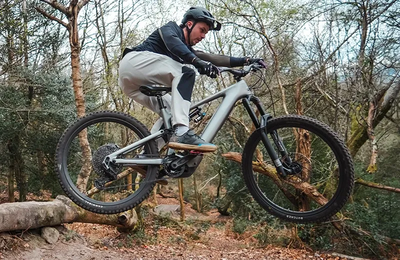 Specialized Levo Evo in the air on a trail jump